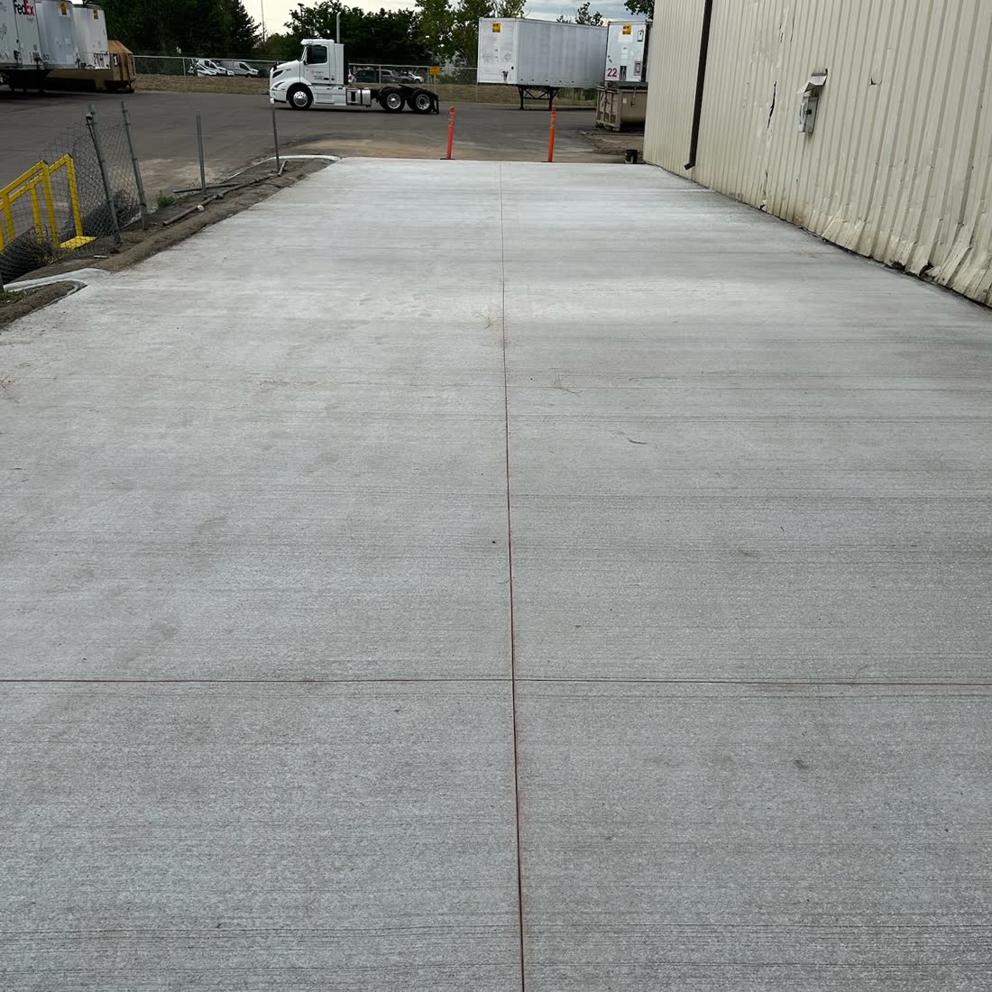 New commercial drive lane beside a warehouse