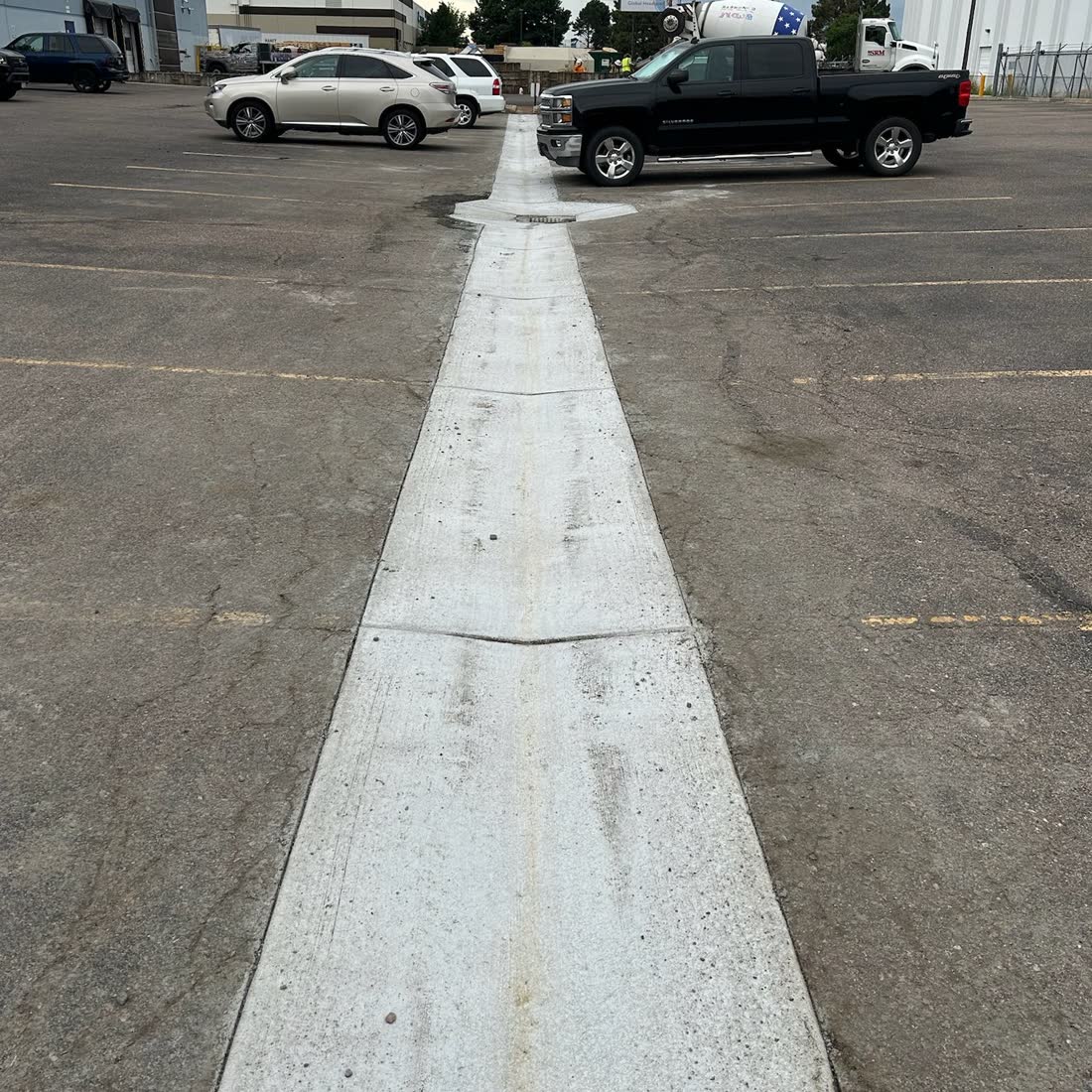 New concrete strip through a parking lot