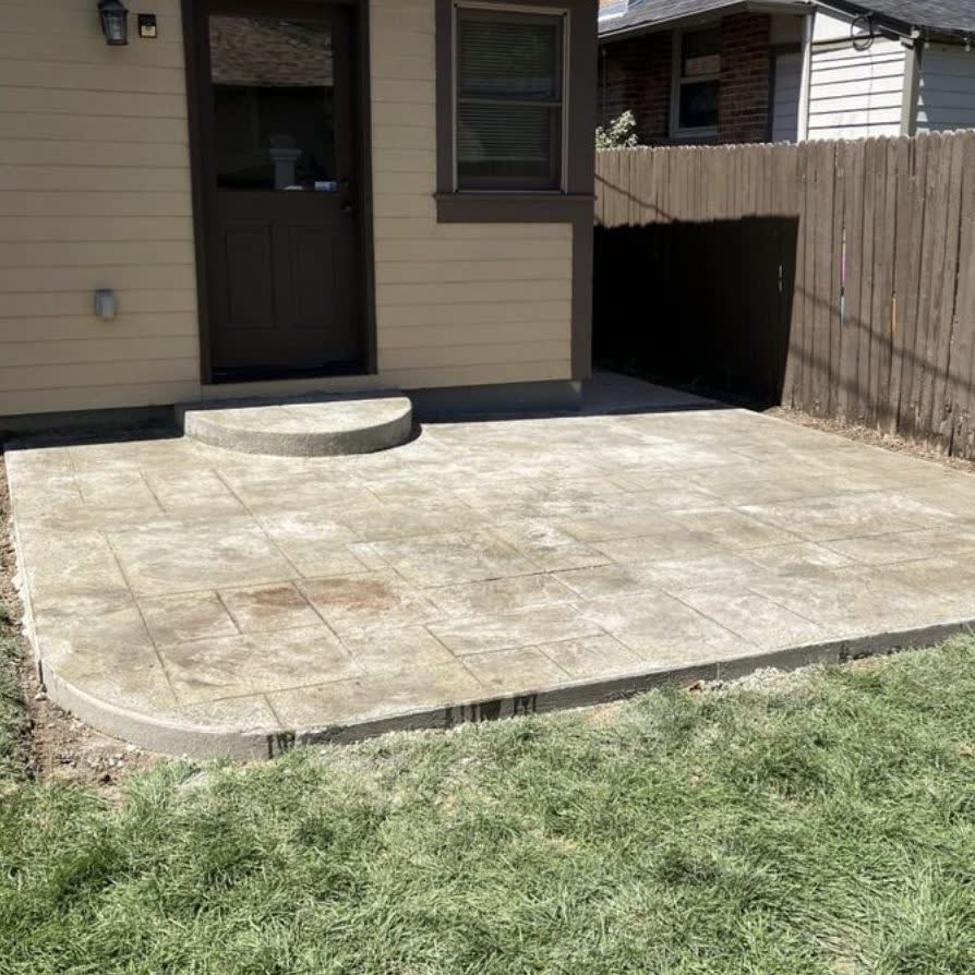 Backyard concrete slab under a deck