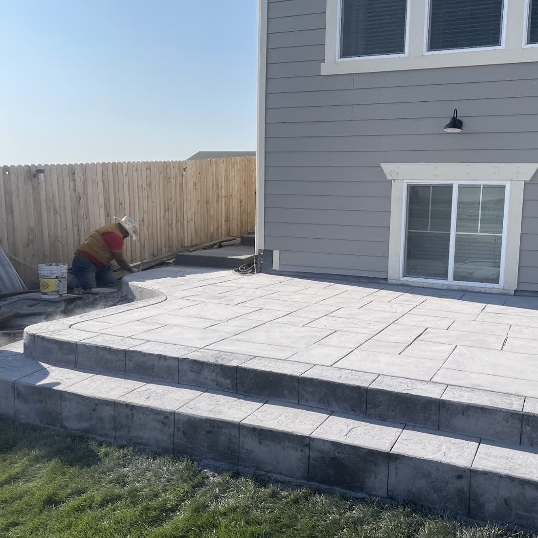 Segal crew finishing a stamped concrete patio with wide steps