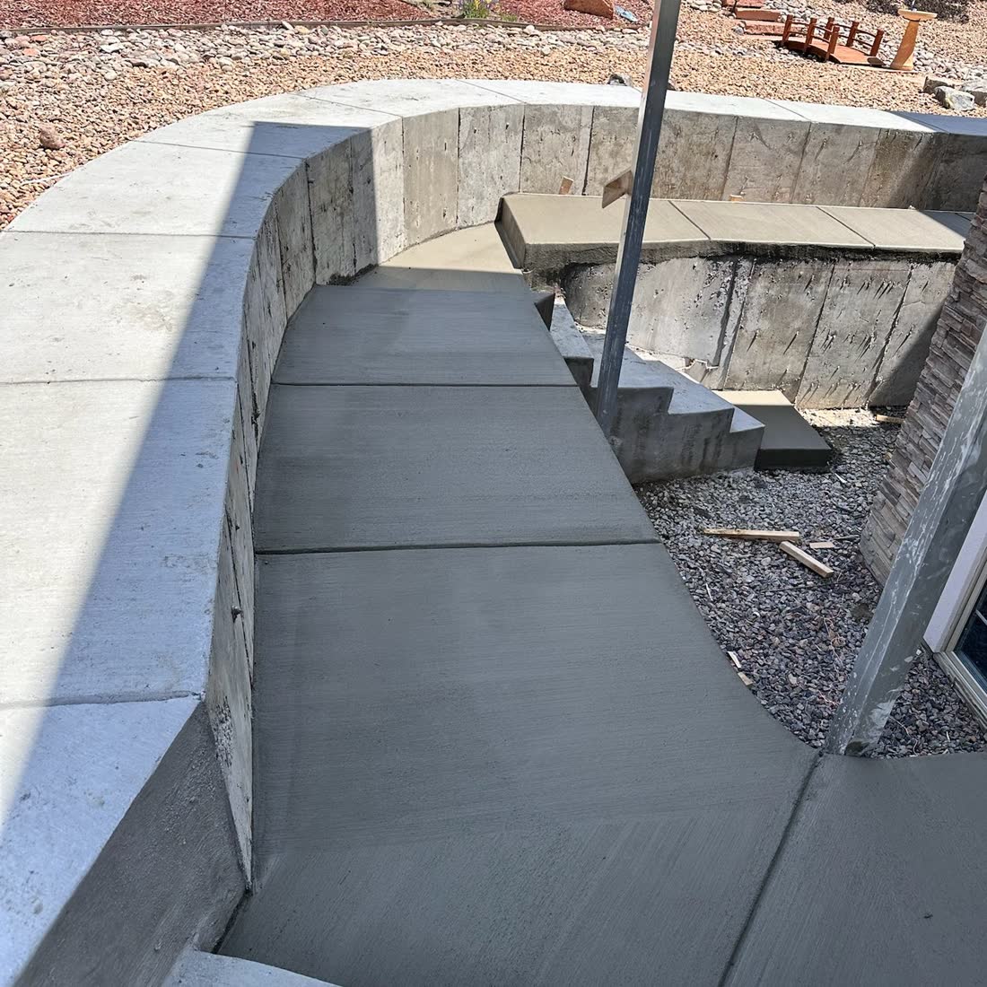 Retaining wall and concrete walkway